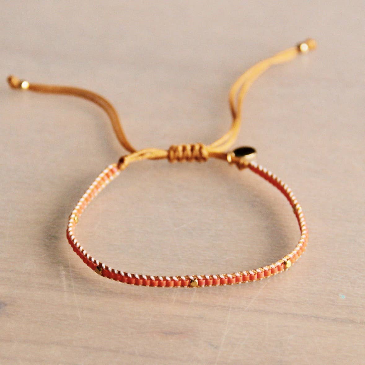 Weaving bracelet with 1 block – orange/goldplated